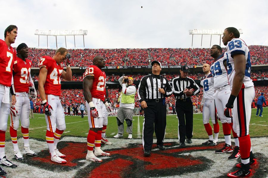 Players from the Kansas City Chiefs (left) and players from the Buffalo Bills (right) wait in anticipation to see the results of the coin toss.