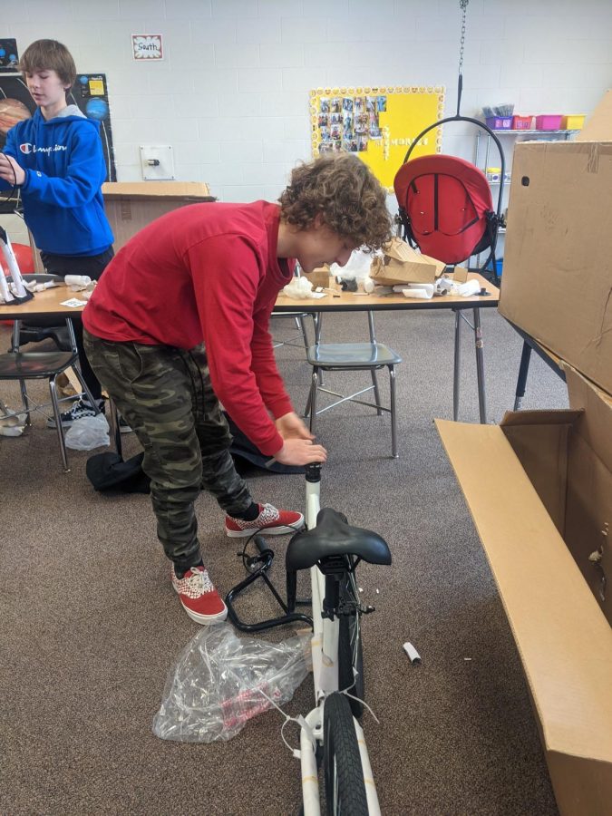 Assembling+a+Strider+Bike%2C+junior+Jenson+Groff+spends+a+portion+of+his+last+day+of+winter+break+with+the+cycling+team+in+order+to+help+provide+for+the+ACP+students.+Building+these+bikes+helped+allow+a+new+learning+tool+the+ACP+students+can+depend+on+for+not+only+their+learning+but+for+their+physical+advancement+too.+%E2%80%9CWe+were+able+to+build+these+Strider+Bikes+bought+by+the+ACP+program%2C%E2%80%9D+Groff+said.+%E2%80%9CI+saw+this+as+a+way+to+help+provide+for+the+students+with+something+they+can+benefit+from.%E2%80%9D+