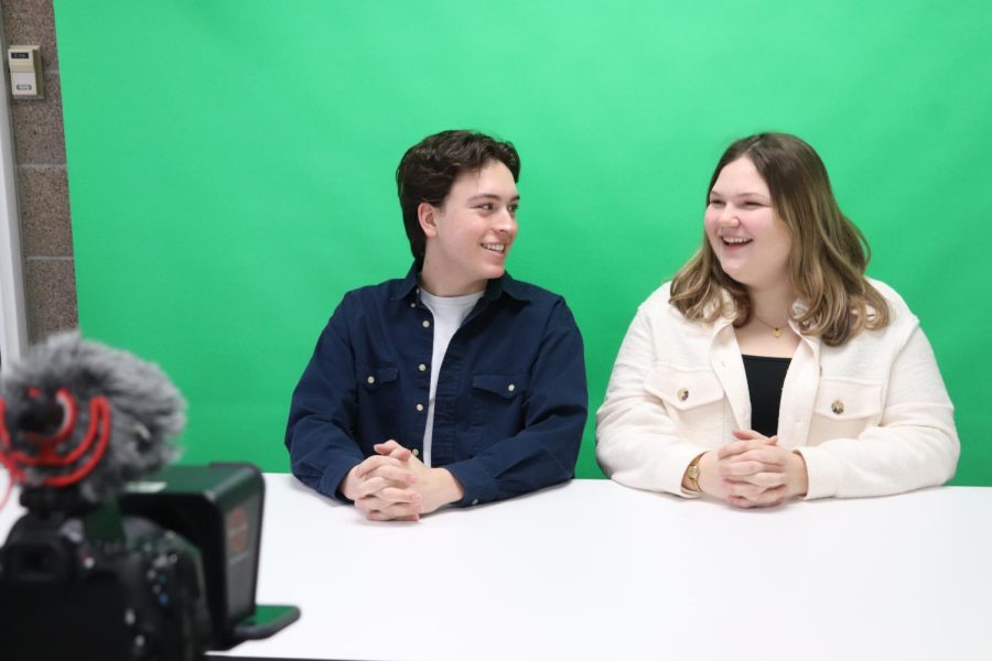 In+order+to+create+a+weekly+broadcast%2C+Senior+Kaden+Roth+and+Kaitlin+Reynolds+collaborate+together+to+anchor+for+the+MWHS+Wildcat+news.+The+anchors+prepare+for+the+weekly+broadcast+and+film.+%E2%80%98The+most+rewarding+part+is+knowing+that+I+am+creating+a+broadcast+that+will+be+enjoyed+by+my+community%2C%E2%80%9D+Reynolds+said.+%E2%80%9CTheres+a+lot+of+work+that+goes+into+each+broadcast%3A+writing+a+script%2C+performing+the+segments+and+repeating+if+any+issues+arise.%E2%80%9D+