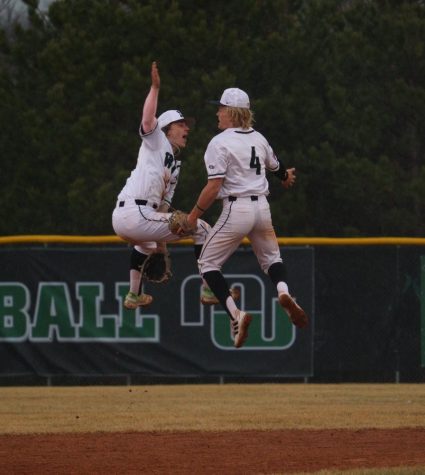 Seniors Maddux Fleck and Drew Borner celebrate the Wildcats win with a high-flying high-five.