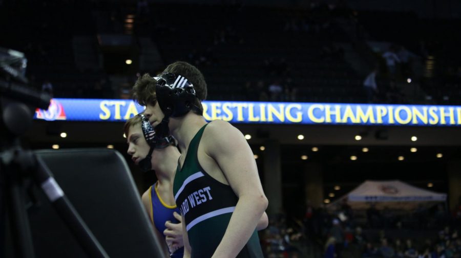 Junior Avery Russel checks in for his match in the first round of consolations.