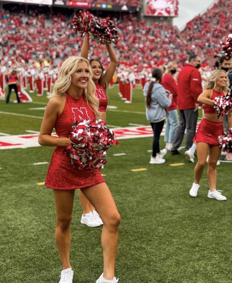 Standing on the sideline of a Nebraska football game, Husker Scarlet Caroline Unger cheers on the Huskers. Unger has been a part of the Scarlets for all of her years at UNL and has danced for all of her life. “As a Husker Scarlet I learned the skill of balancing responsibilities, I determine my priorities, make lists and work hard to get everything done well,” Unger said. “I am so excited to be back at my alma mater dance team where I get to lead amazing girls on an elite team that I could not be more proud of to be a part of.”