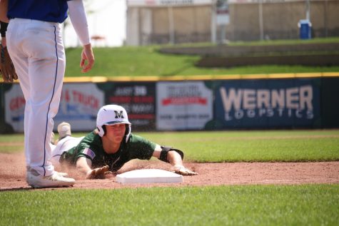 Moore dives into third base on his RBI triple against the Kearney Bearcats. Millard West won 3-0.