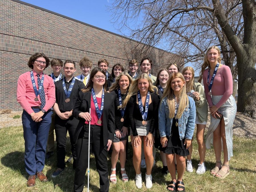 Millard West journalism staff poses for a photo with their medals at NSAA State Journalism. The staff took third place overall.  “It was good to have awards in person,” adviser Mark Hilburn said. “I think the students deserve to be recognized in person for their work and not in a video a few days later.”