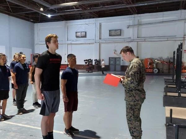 Senior Peyton Overman stands at attention during the military fitness training. He has spent the past year preparing for enlistment both physically and mentally. “I’ve been working at General Store Company to help with my supplement knowledge and sales experience,” Overman said. “Hearing that Marine Corps boot camp is the hardest has really motivated me to go to the gym and make healthier lifestyle choices. I have been studying Marine Corps history and basic knowledge to help me at boot camp.”
