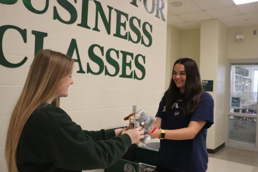 Sophomore Emma Perman gives stuffed animals to a HOSA member, sophomore Emma McGargill. It’s just a good thing to do because whoever is receiving them will be really happy and it’s good to help out kids who might not be as fortunate and as healthy as me, Perman said. I’m really glad I got to participate in the stuffed animal drive.