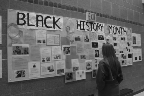 Stopping at the display outside the library, senior Ally Fortney observes the Black History wall created by the Justice and Diversity League. Throughout the month of January, the group of students did plenty of research to get as many prominent African American leaders on the wall as possible. “Even though this display has been up every year since my freshman year, this was really the first time I really took the time to read through it,” Fortney said. “I really wish more people did so because I know there is so much history and we don’t always have the time or resources to cover all of it during structured class time.” 