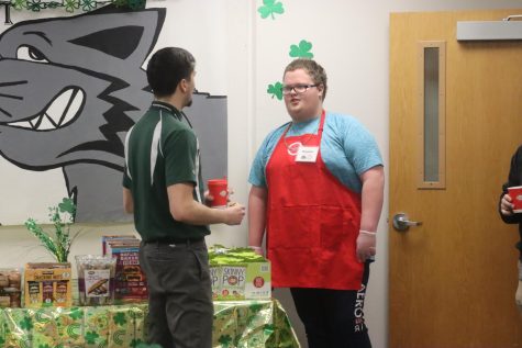 Senior Hunter Pratt helps science teacher Parker Lower in the Wildcat Cafe for Teacher Appreciation Day. 