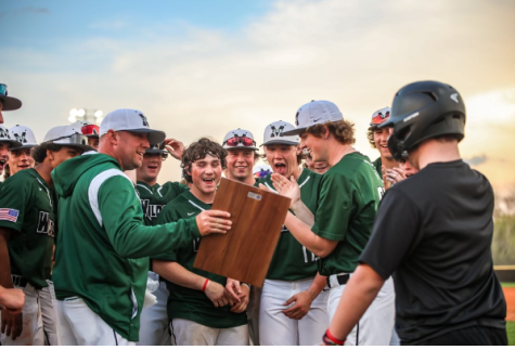 Head coach Steve Frey holds up the Metro Conference plaque for his team to see. “It’s pretty cool to win that,” junior infielder and Creighton pledge Nick Ventiecher said. “But it’s just another step to get to the bigger stage. We are a lot younger team this year, but we can still win it all.” Millard West won 10-6 over Q-Street and district rival Millard South in the championship round of the tournament. Photo courtesy of Anna Burton.