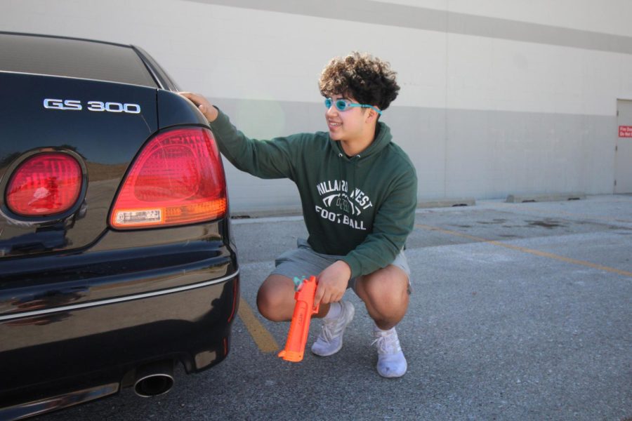 Camping out in the parking lot, senior Ernie Miranda prepares to wait as long it takes to capture his target. For this particular assassination, Miranda figured out where his target worked and the time they normally got there. “The key to success with Senior Assassin is to wait around for people much longer than anyone would ever expect you to,” Miranda said. “You also have to study the Life360 circle to find patterns throughout your targets day if you really want to win.” Photo by Kelsey Nunnenkamp 