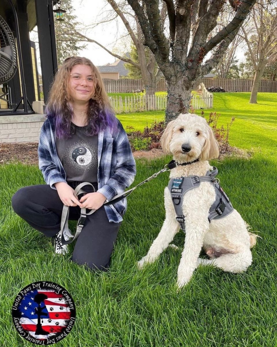 Gabrielle Wardyn and Waffles pose for a picture after completing his autism awareness service dog training. The week-long assessment and training required a lot of physical and mental training that not all dogs qualify for. Now, Waffles is trained for both outside and inside school-related events. “I immediately saw a change in Waffles behavior,” Wardyn said. “Very alert and aware of his surroundings.”