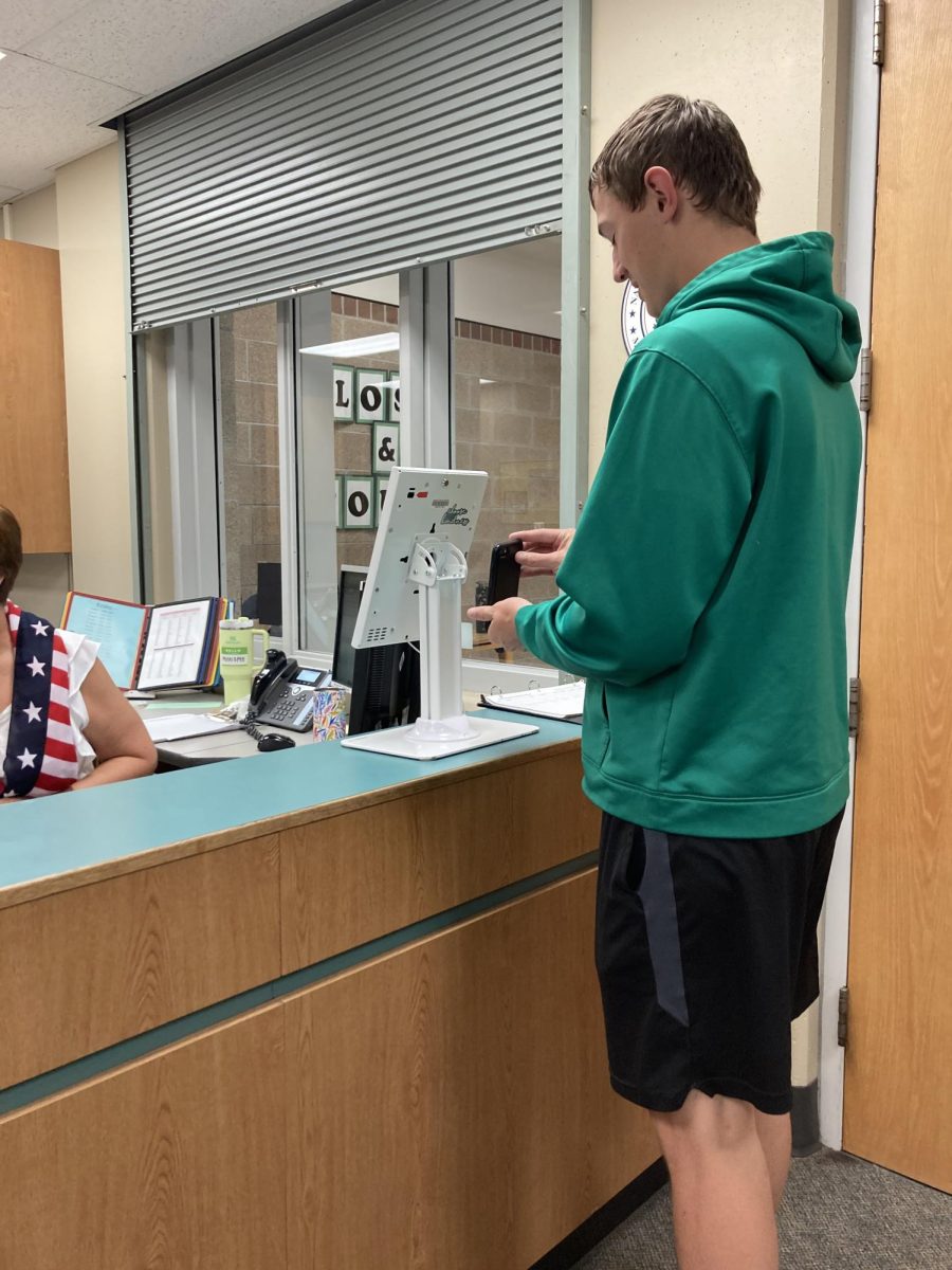 Senior Nathan Delaney signs in on the Studentvue kiosk as he arrives at school late. Delaney is a good student who is on time to class most of the time and ready to learn when the bell rings. “I try to leave my house at a good time in the morning so Im not late, said Delaney. “Even when Im late getting a pass to class is very quick and it doesnt take too long for me to grab a pass and get to class.”
