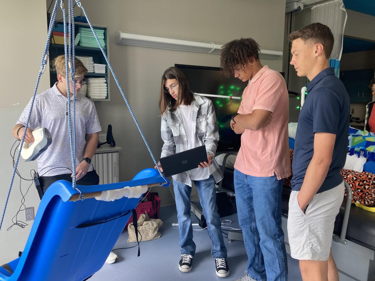 Students in STEM academy, seniors Luke Lombardo, Landon Chessareck, Nathan Durand and Andrew Johnson, work on an adaptive swing while visiting J.P. Lord. When building, they are taking into account that this swing will be made for sensory purposes. “We have been working on this swing all year,” Johnson said. “It’s the biggest project we have and will be the most impactful for J.P. Lord students.”
