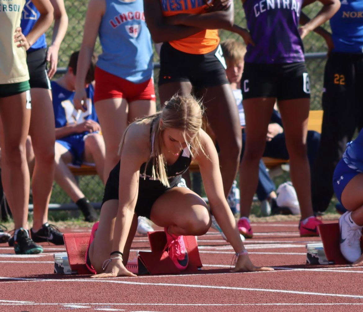 Junior Avery Kephart lining up behind the start before her 100 meter dash. At the Jo Dusatko Omaha Central invite, Kephart ran the the 100 meter dash, 200 meter dash and 4x1. “This was my first season doing track and one thing I can say is that it taught me how important it is to take care of yourself, especially your mental health,” Kephart said. “Running is very mentally challenging, especially when you are trying to live up to others expectations, trying to manage school and not burnout. The pressure that was put on me during track definitely tested my love for this sport.”
