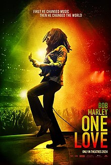 This is the poster for the “Bob Marley: One Love” movie. It shows Bob Marley’s actor performing on stage while a ray of light, in the colors of Jamaica’s flag, shines on him. This shows what is important to him and what had done for the country of Jamaica. 