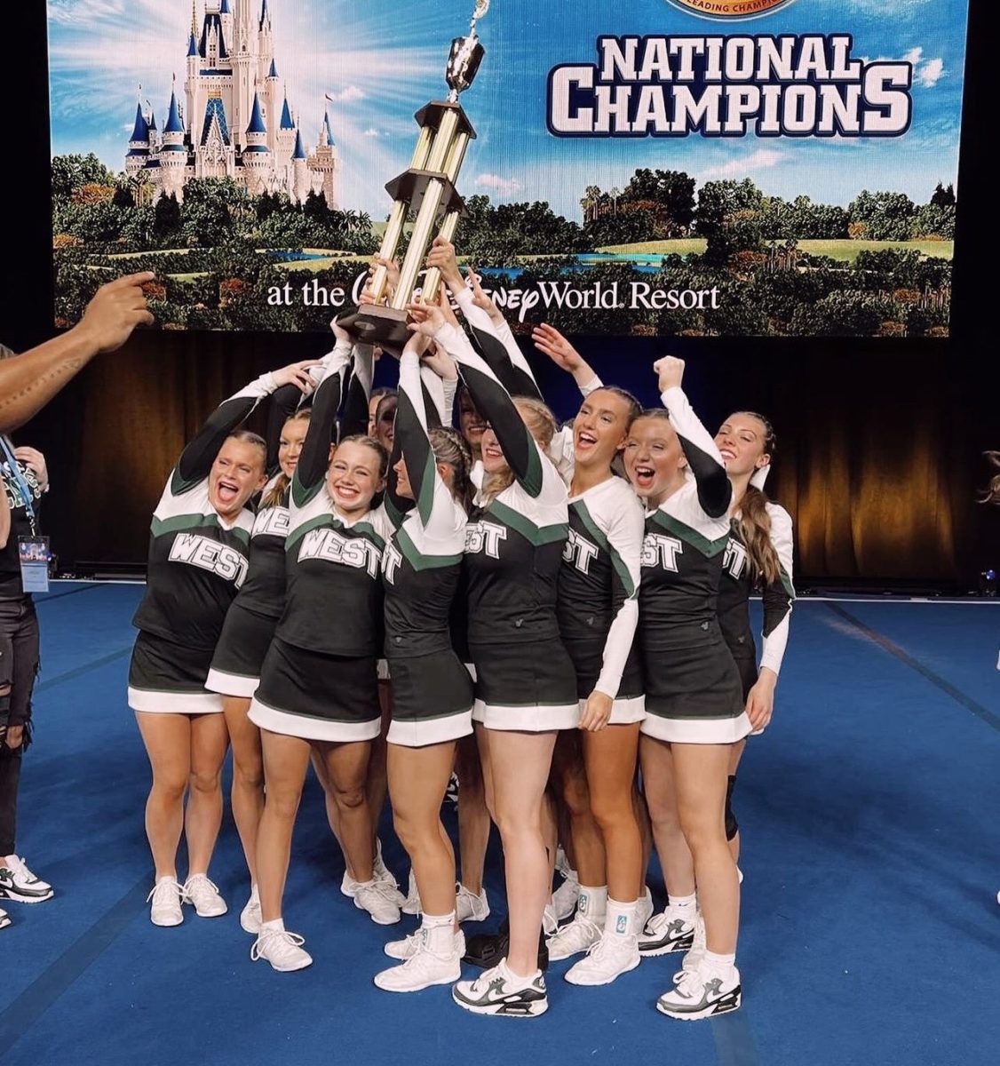 Smiling+with+excitement%2C+senior+Haili+Foster+celebrates+with+her+teammates+after+winning+their+second+first+place+trophy+at+Nationals.+Foster+has+been+on+MWVC+for+four+years+now+and+this+will+be+the+first+time+in+history+that+they+will+be+leaving+with+not+only+one+but+two+white+jackets.+%E2%80%9DThis+truly+was+a+dream+come+true%2C%E2%80%9C+Foster+said.+%E2%80%9CAll+season+long+we+have+been+working+day+in+and+day+out+for+this+moment.+Hearing+our+name+called+out+for+first+place+in+Game+Day+and+Tumbling+was+such+an+exciting+and+joy-filled+moment.%E2%80%9D
