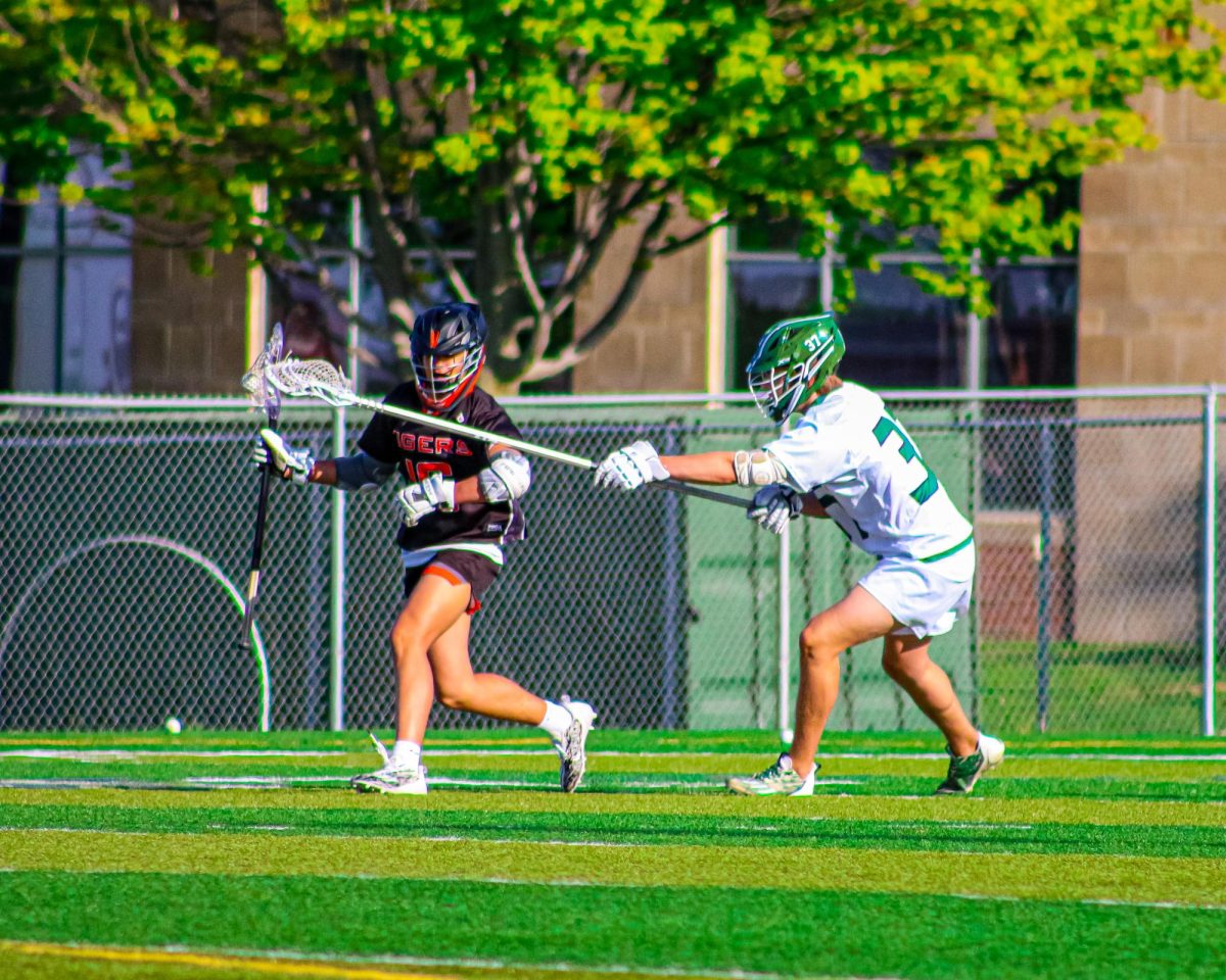 Holding off an attacking Tiger, sophomore Spencer Stutheit forces an outside shot. Millard West won 8-7.