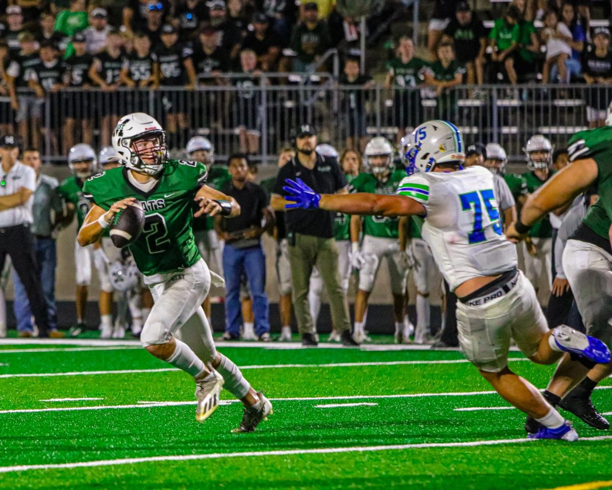 Escaping the pocket, senior quarterback DJ Schiemann evades a Mustang near the endzone in the final seconds. Schiemann and the Wildcats found their groove within the final quarter, but were unable to complete the comeback, falling just short and the one-yard line. “During that last drive, I was thinking to myself that we had a shot to win this thing,” Schiemann said. “On that last play, I wanted to hit a slant or Breck on his route which would’ve been a touchdown. Unfortunately, the pocket collapsed beside me, making me go up the middle and get just short of the endzone."
PHOTO BY: CHLOE VAUGHN