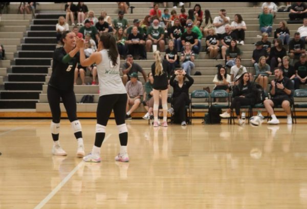 The dynamic duo celebrates a kill with a high five during a crucial moment in the game against Norfolk. Their leadership and teamwork will continue to inspire the Wildcats in their final high school season. “Every time I’m on the court I’m just excited to be there,” Hart said. “I feel so blessed to have such a great team of girls to play with this year and next year in college.”