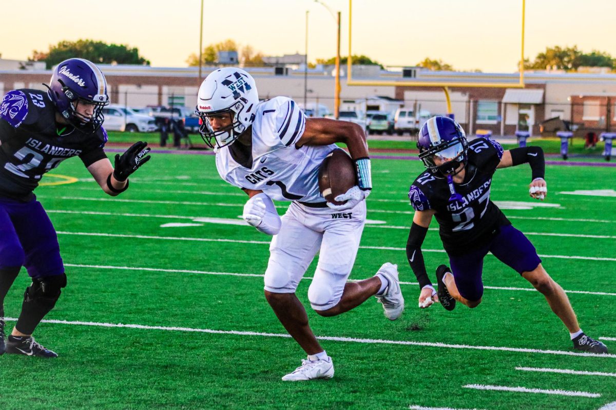 Speeding past defenders, senior wide receiver Michael Coleman eyes the endzone. Coleman picked up two first half touchdowns to lead the Wildcats to a 42-14 thrashing of Grand Island. “It felt great being a part of the team’s success after having the first four games not go the way we wanted,” Coleman said. “This win for the team was important so we could have a chance to make the playoffs. We keep getting better each week and want to make a run.”