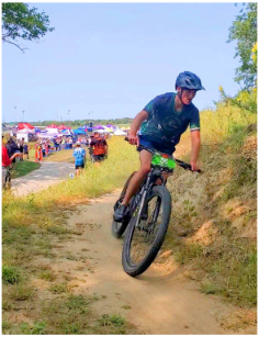 In a hurry to finish the race, junior Nathan Biles cycles on the course representing Millard West’s mountain biking team. Biles built a sturdy bike from scratch, from his many rough drafts to finally experiencing his finished product on the courses. “Somehow this bike was faster than the one I normally race on,” Nathan Biles said. “It had impressive riding characteristics and performs 100 times better than imagined other than a bit too much flex.”