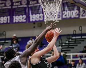 Driving towards the basket, sophomore Cade Walker draws contact to the face on his way up. Millard West defeated the Chieftains 57-49.