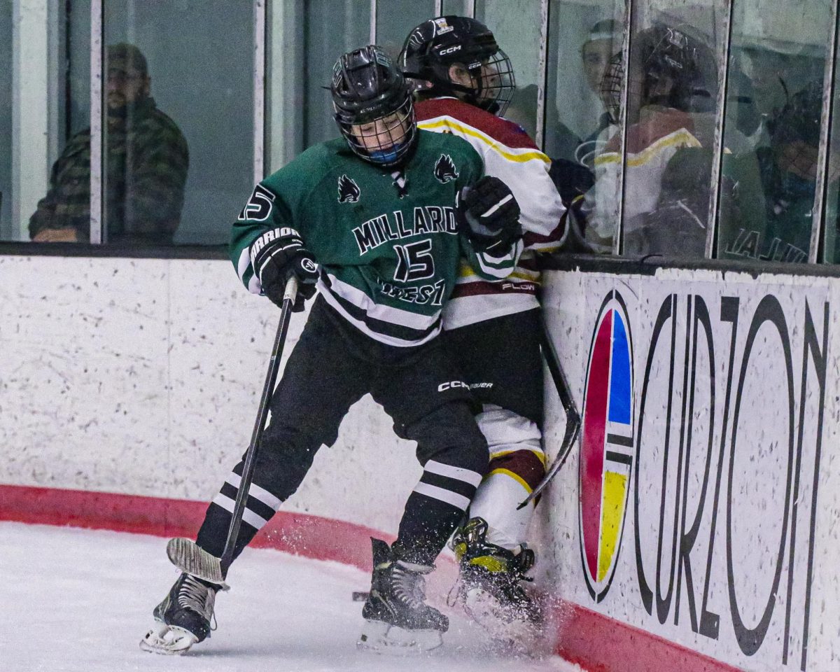 Crashing into his opponent, freshman forward Alex Beacon lays the body on a Papio defender. Millard West defeated Papio 2-1.