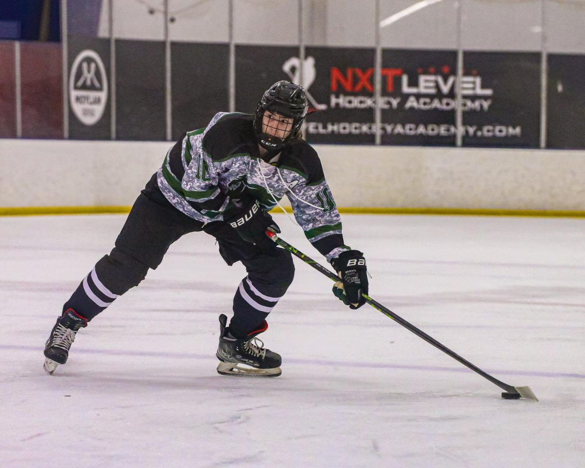 Loading up his shot, junior defenseman Gavin Spencer prepares to fire from the blue line. Spencer’s efforts led him to a multi-point game in the 3-1 win over Lincoln Capitals West. “We knew we’re the better team so we just wore them down all game,” Spencer said. “In the third when they were tired and upset, it allowed us to calm down the game. It also led to us being able to make good heads-up plays to one another.” 