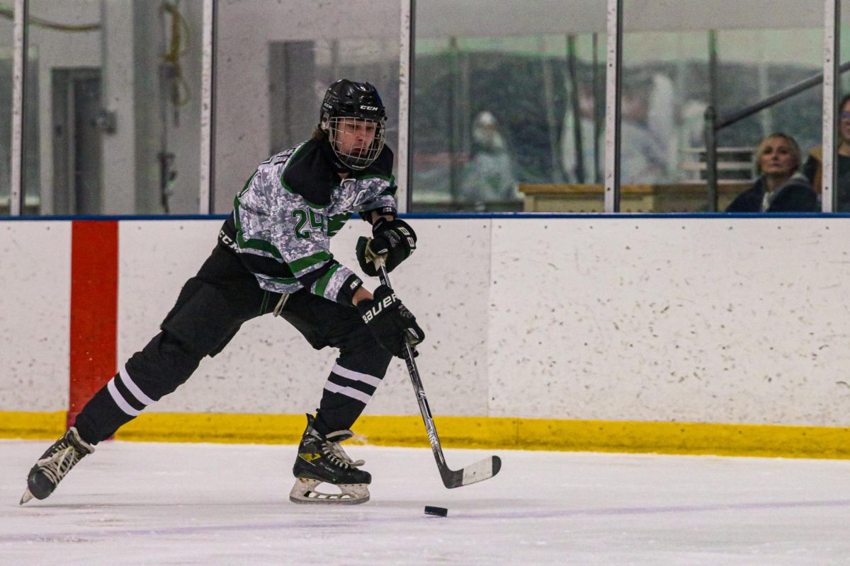 Speeding up ice, senior defenseman Cole Grandgenett controls the puck. Defensively, Grandgenett led the way for the Wildcats collecting multiple takeaways en route to the loss. “I think the biggest takeaway is simple. The depth of the team needs to grow,” Grandgenett said. “We had a total of 20 shots but they mostly consisted of shots from really only five players at most. This has been a problem all season. We need players to gain their confidence and start producing plays according to their style.”