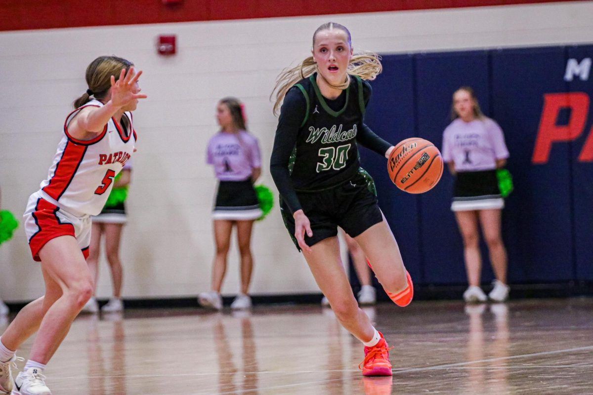 Dribbling past the defenders, senior Norah Gessert tries to find herself a lane to drive in the paint to work herself to the hoop and make a basket to help lead her team to a victory. During the game she scored 12 points and had three rebounds. “I try to find open lanes if possible and I know if I can’t then I will have a teammate by me that I can pass it to,” Gessert said. “We are always trying to score points no matter what way it happens.”