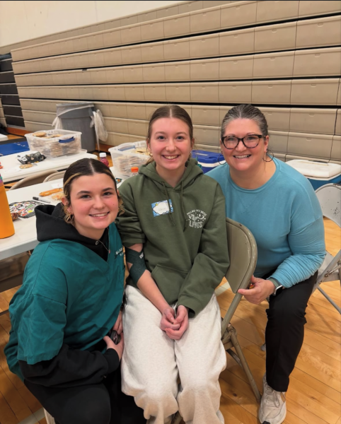 Freshman Olivia Goedecker, junior Addison Goedecker and parent Lori Goedecker smile at the camera after having drawn and donated blood.

"It makes me happy to help others," said Addison. "I do it whenever I can."