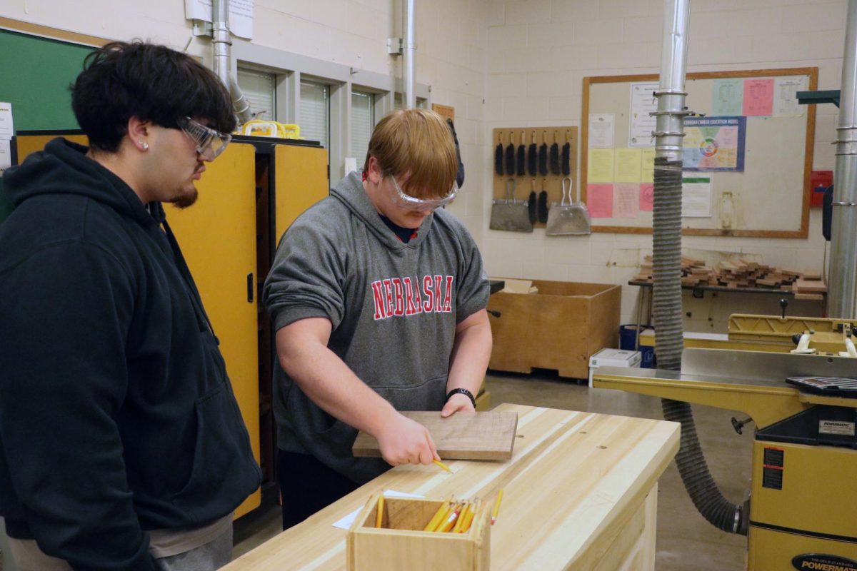 Checking the edges of his board, junior Matthew Porter checks the edges of his piece to sand down. Not every one comes perfect, so the class works to get them smooth to get them ready “I haven’t really struggled with any of my pieces,” Porter said. “I have had bad pieces, but I was able to fix them.